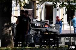 Investigators work at the site where a Ukrainian drone was downed by air defense system, in central Rostov-on-Don, Russia, Sept. 7, 2023.