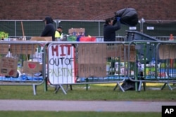 Workers dismantle the pro-Palestinian encampment at the Massachusetts Institute of Technology, after police cleared the encampment before dawn, May 10, 2024, in Cambridge, Mass.