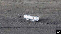 A suspicious object is seen on the ground where a suspect was arrested before Japanese Prime Minister Fumio Kishida was to begin his speech, in Wakayama, Japan, April 15, 2023.