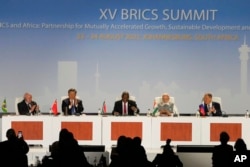 FILE - China's Xi Jinping, 2nd left, is among the leaders attending the BRICS summit in Johannesburg, Aug. 24, 2023.