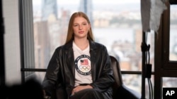 FILE - American swimmer Lydia Jacoby, 20, answers questions during an interview, Apr. 17, 2024, in New York. Jacoby was a breakout star in the pool at the last Summer Games, earning a gold medal in the 100-meter breaststroke and a relay silver.