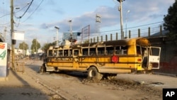 A bus set on fire by gang members in Port-au-Prince, Haiti, Feb. 29, 2024. Gunmen shot at the international airport and other targets in a wave of violence that forced businesses, government agencies and schools to close early.