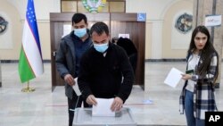 A man casts his ballot at a polling station during the presidential election in Tashkent, Uzbekistan, Oct. 24, 2021.