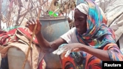 Fatma Idriss of Sudan cooks in a refugee camp in Adre, Chad, on Sept. 13, 2023.