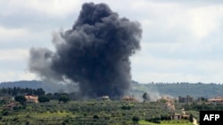 Smoke billows after an Israeli strike on the southern Lebanese border village of Tayr Harfa on April 6, 2024.
