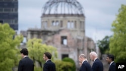 Leaders of the Group of Seven nations' meetings walk before the Atomic Bomb Dome, during a visit to the Peace Memorial Park as part of the G7 Leaders' Summit in Hiroshima, Japan, May 19, 2023.