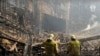 FILE - In this photo taken from video released by the Investigative Committee of Russia on March 23, 2024, firefighters work in the burned concert hall after an attack on the building of the Crocus City Hall in Moscow. The attack left 145 dead.