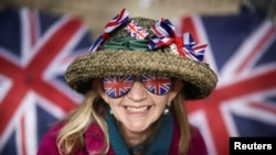 A royal fan, Sally Scott, poses on the Mall outside Buckingham Palace ahead of the Coronation of Britain's King Charles and Camilla, Queen Consort, in London, May 4, 2023. 