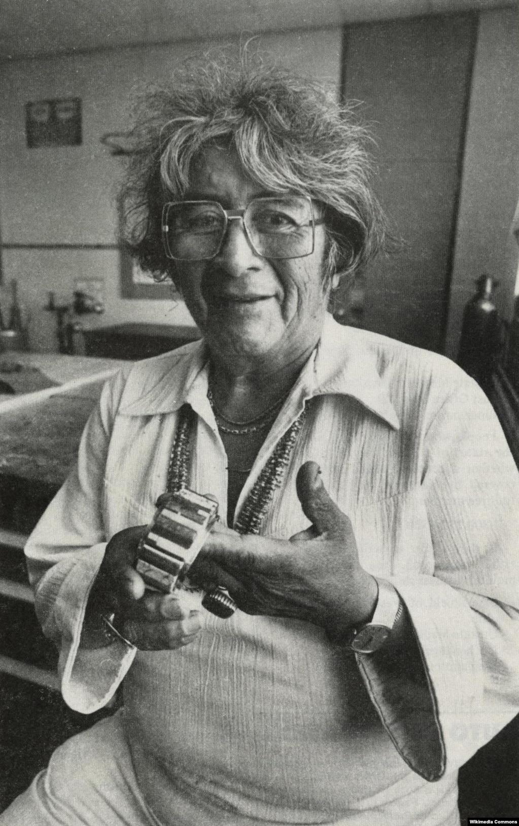 Navajo jeweler Charles Loloma is pictured holding one of his iconic inlaid bracelets.