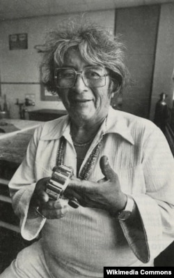 Navajo jeweler Charles Loloma is pictured holding one of his iconic inlaid bracelets.