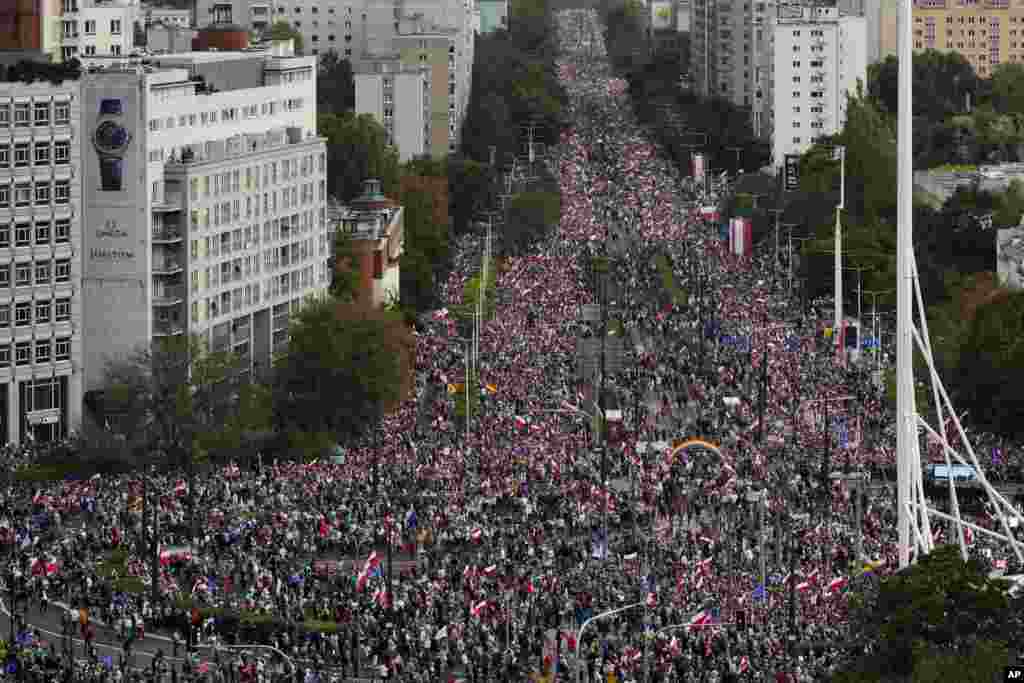 Thousands of people gather for a march to support the opposition against the governing populist Law and Justice party in Warsaw, Poland.