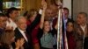 Mexican President Andres Manuel Lopez Obrador raises the hand of Claudia Sheinbaum, the ruling party's candidate for the upcoming presidential elections, during a ceremony to giver her the party's command staff, in Mexico City, Sept. 7, 2023.