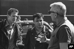 FILE - Director Richard Brooks, right, makes a point while talking to actors Scott Wilson, left, and Robert Blake during filming of the adaptation of the book "In Cold Blood" in March 1967 in Kansas City, Kansas.