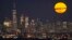 FILE - The moon rises through clouds over the skyline of lower Manhattan in this view from West Orange, N.J., Aug. 1, 2023, during a supermoon period. 