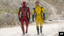 Ryan Reynolds as Deadpool/Wade Wilson, left, and Hugh Jackman as Wolverine/Logan are shown in a scene from "Deadpool & Wolverine." (20th Century Studios/Marvel Studios via AP)