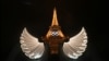 The Eiffel Tower is illuminated with wings in the foreground after the opening ceremony of the Paris 2024 Olympic Games, July 26, 2024. 