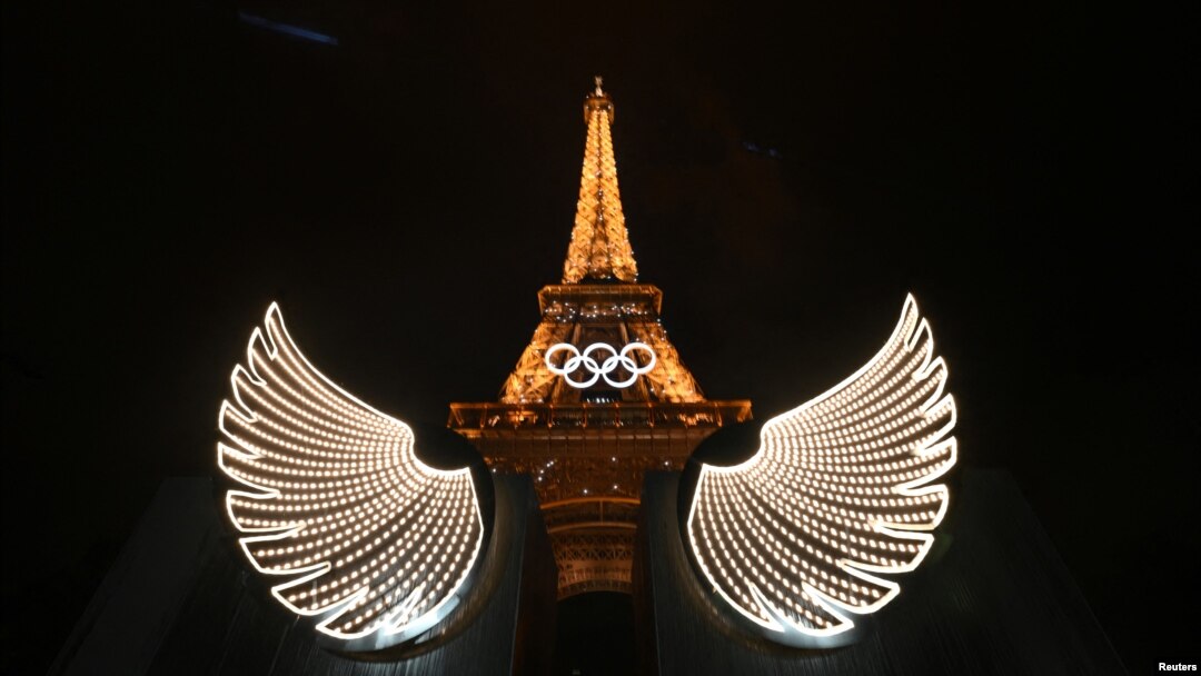 The Eiffel Tower is illuminated with wings in the foreground after the opening ceremony of the Paris 2024 Olympic Games, July 26, 2024. 