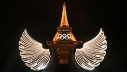 The Eiffel Tower is illuminated with wings in the foreground after the opening ceremony of the Paris 2024 Olympic Games, July 26, 2024. 
