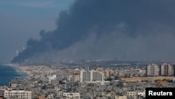 Smoke rises from the Israeli side after Palestinian Hamas gunmen infiltrated areas of southern Israel, as seen from Gaza, Oct. 7, 2023. 