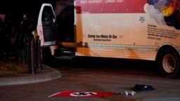 A Nazi flag and other objects recovered from a rented box truck are seen on the ground as law enforcement agencies investigate the truck that crashed into security barriers at Lafayette Park across from the White House in Washington, May 23, 2023.