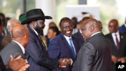 FILE - South Sudanese President Salva Kiir Mayardit, left, shakes hands with Pagan Amum Okiech of the Real-SPLM group during peace talks in Nairobi, Kenya, on May 9, 2024. 