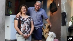 Fabricio Chicas, a transgender man, right, poses for a photo with his partner Elizabeth Lopez, and their pets, at their home in San Salvador, El Salvador, April 30, 2023. 