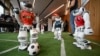 Robots of the Zurich Federal Institute of Technology play a football game during the International Telecommunication Union (ITU) AI for Good Global Summit in Geneva.