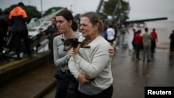 People react after being rescued from flood in Porto Alegre, in Rio Grande do Sul, Brazil, May 4, 2024.