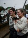 People react after being rescued from flood in Porto Alegre, in Rio Grande do Sul, Brazil, May 4, 2024.