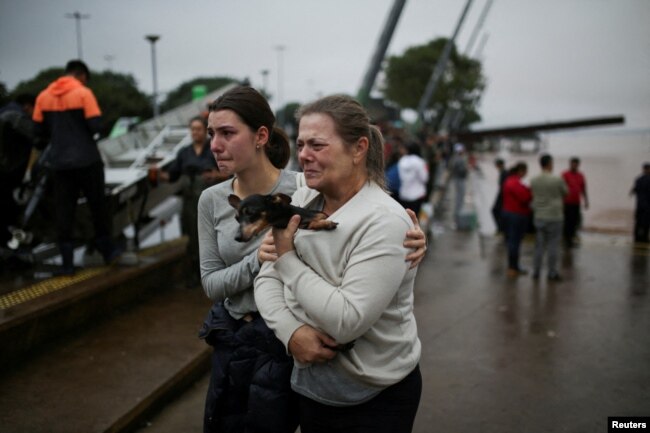 FILE - People react after being rescued from flood in Porto Alegre, in Rio Grande do Sul, Brazil, May 4, 2024. (Reuters Photo/Renan Mattos)