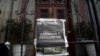 FILE - A copy of the front page of the newspaper 'El Periodico de Guatemala', that reads in Spanish 'Journalists killed' hangs on a main gate of the Presidential House, Guatemala City, March 11, 2015. 