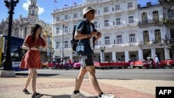 Dos turistas captados por una calle de La Habana el 20 de diciembre de 2023. La economía de Cuba se ha contraído más de un 2% el último año, el gobierno reconoce que el país sufre un estancamiento económico.