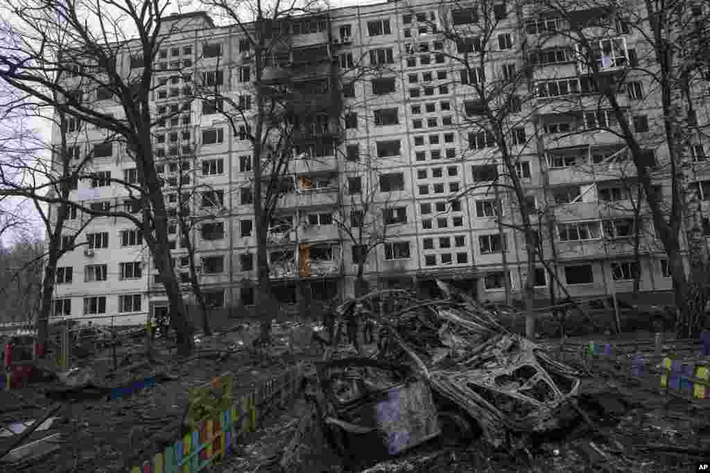 A destroyed car is seen in the yard of a kindergarten after Russian rocket attack at residential neighborhood in Kyiv, Ukraine.