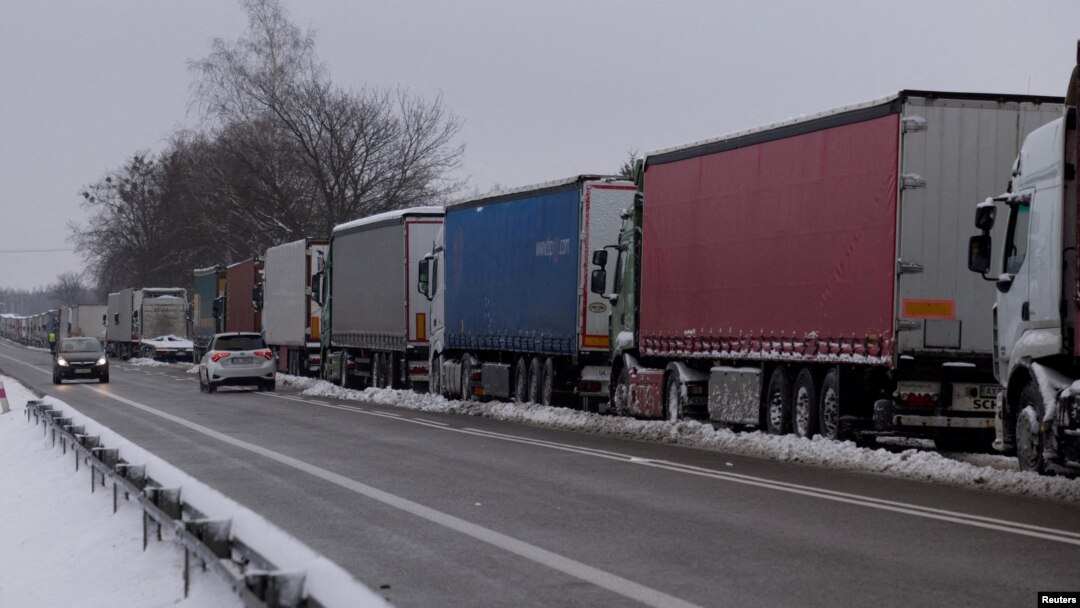 FILE - Trucks line up in a long queue to cross the Polish-Ukrainian border at the Dorohusk-Jagodzin crossing, in Okopy, Poland, Dec. 4, 2023.