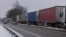 FILE - Trucks line up in a long queue to cross the Polish-Ukrainian border at the Dorohusk-Jagodzin crossing, in Okopy, Poland, Dec. 4, 2023.