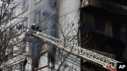 Firefighters put out fire after a Russian missile hit a residential multi-story building in southeastern city of Zaporizhzhia, Ukraine, March 22, 2023.