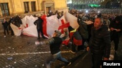 Protesters gather in front of police officers during a rally against the "foreign agents" law in Tbilisi, Georgia, March 7, 2023.