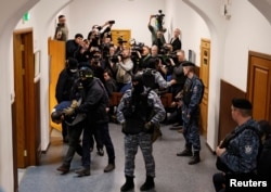 Saidakrami Murodali Rachabalizoda, a suspect in the shooting attack at the Crocus City Hall concert venue, is escorted after a court hearing at the Basmanny district court in Moscow, Russia, March 24, 2024.