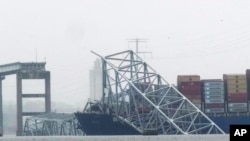 A container ship rests against the wreckage of the Francis Scott Key Bridge on March 28, 2024, in Baltimore, Maryland. Officials are turning their attention to what promises to be a massive salvage operation. 