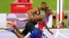 Quincy Hall of the United States crosses the finish line followed by Matthew Hudson-Smith of Britain in the men's 400-meter final at the 2024 Summer Olympics, Aug. 7, 2024, in Saint-Denis, France.