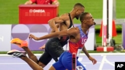 Quincy Hall of the United States crosses the finish line followed by Matthew Hudson-Smith of Britain in the men's 400-meter final at the 2024 Summer Olympics, Aug. 7, 2024, in Saint-Denis, France.