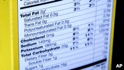 FILE - A nutrition facts label is seen on the side of a cereal box in Washington, D.C, Jan. 23, 2014.