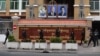 FILE - Police officials walk in front of Phnom Penh Municipal Court in Phnom Penh on March 17, 2022. 