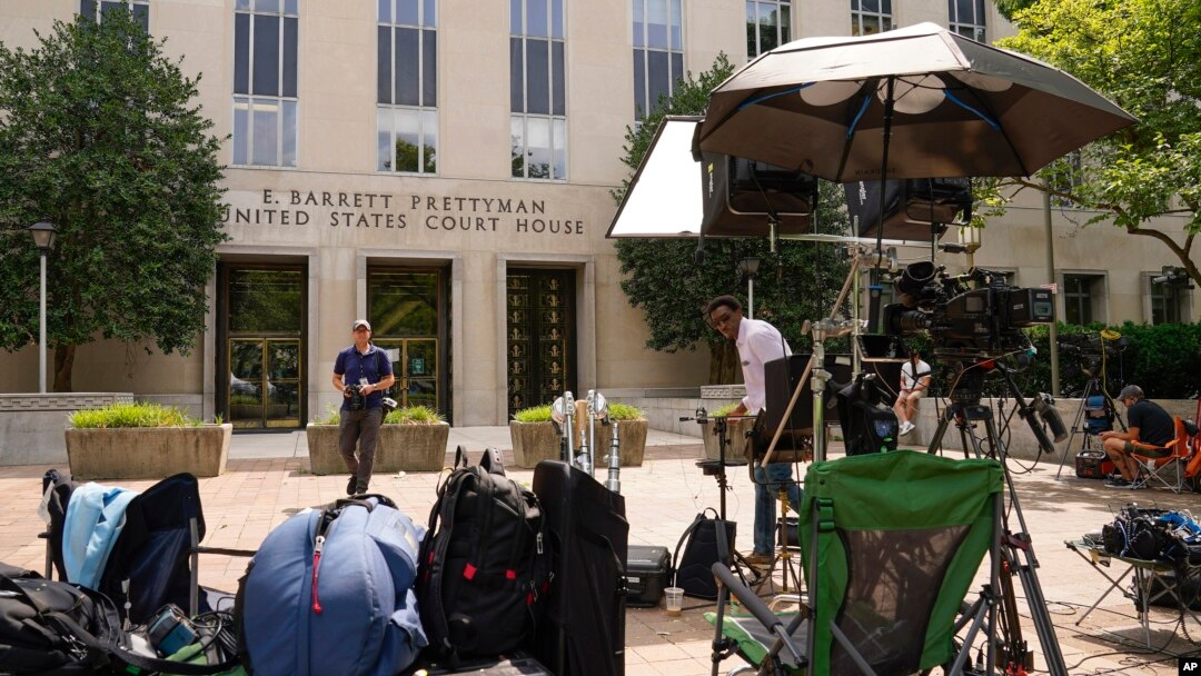 Members of the media linger outside E. Barrett Prettyman U.S. Federal Courthouse, Aug. 2, 2023, in Washington. Former President Donald Trump is due in court on Thursday.