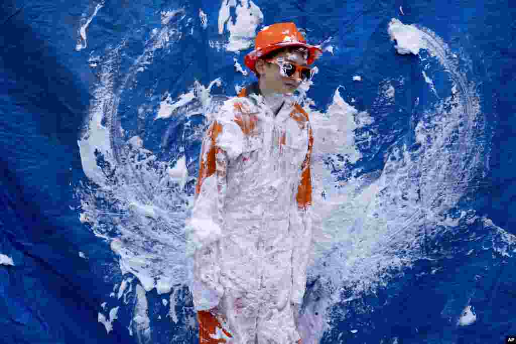 An orange-clad boy waits for people to pay to throw pies during King&#39;s Day celebrations in Amsterdam, The Netherlands.&nbsp;The Netherlands celebrated the 56th birthday of King Willem-Alexander of the House of Orange with street markets, parties and pastries, even as polls showed the monarch&#39;s popularity declining.&nbsp;