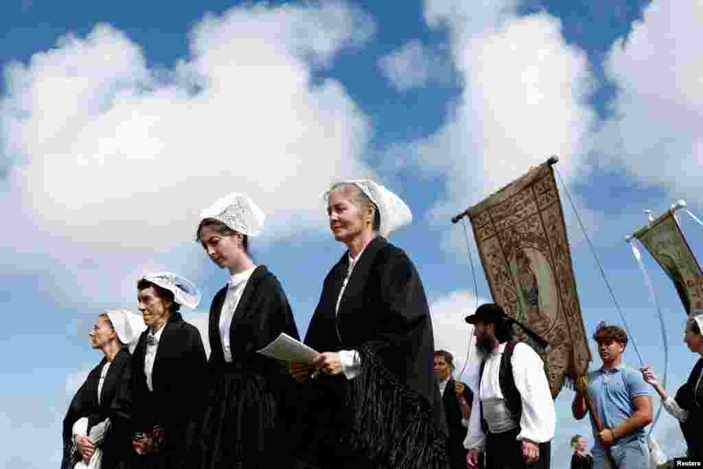 People participate in a traditional religious forgiveness of Notre-Dame de la Clarte on the feast day of the Assumption of Mary in Perros-Guirec, France.