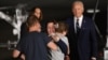 US President Joe Biden and Vice President Kamala Harris watch US-Russian journalist Alsu Kurmasheva, just released from Russia, embraces her family as she arrives at Joint Base Andrews in Maryland on Aug. 1, 2024. 