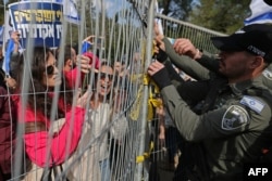 Israeli security forces reinforce fencing outside the Knesset (parliament) in Jerusalem on Feb. 13, 2023, during a rally against controversial legal reforms being touted by the country's hard-right government.