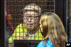 FILE - David Chou, left, speaks with deputy public defender Jennifer Ryan, Aug. 19, 2022, in Santa Ana, California. Chou, of Las Vegas, Nevada, has been charged in connection to an attack that left one person dead and five others injured.