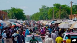 Pedestrians shop at a market in Niamey, Niger, July 24, 2024. One year has passed since a dramatic coup in Niger. 